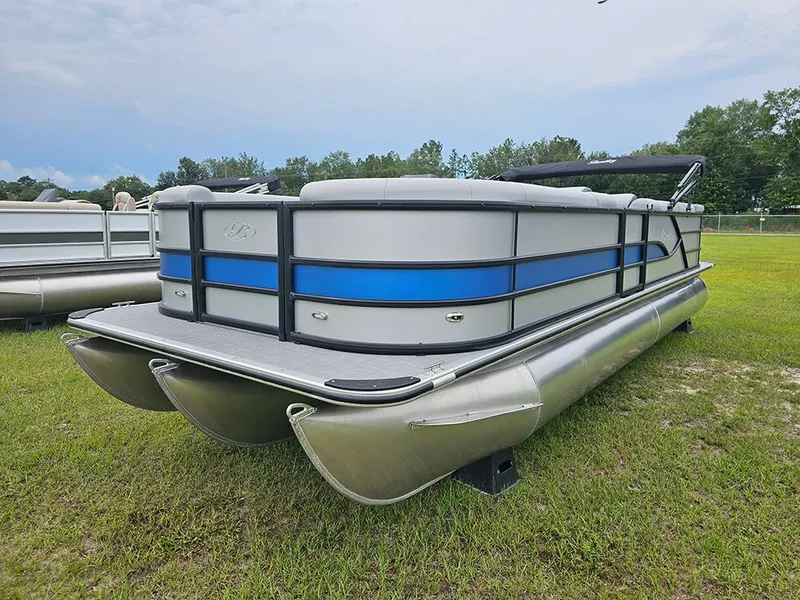 Slide: The Image of 2026 Bentley Pontoons Legacy 243 Cruise on grass, showcasing sleek design and modern features. - 5