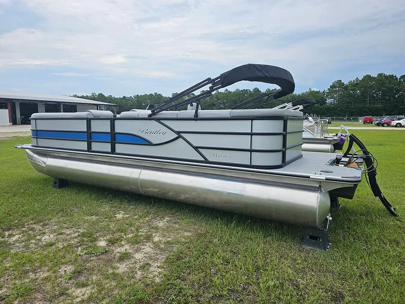 Slide: The Image of 2026 Bentley Pontoons Legacy 243 Cruise on grass, showcasing sleek design and modern features. - 7