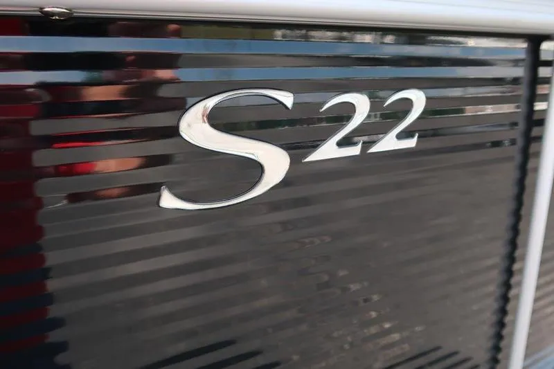 Slide: The Image of Close-up of 2026 Bennington S Quad Bench 22 SSR logo on sleek black surface. - 12