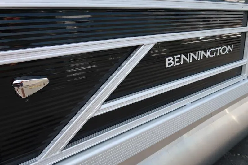 Slide: The Image of 2026 Bennington S Quad Bench 22 SSR pontoon boat, sleek black and silver design. - 14