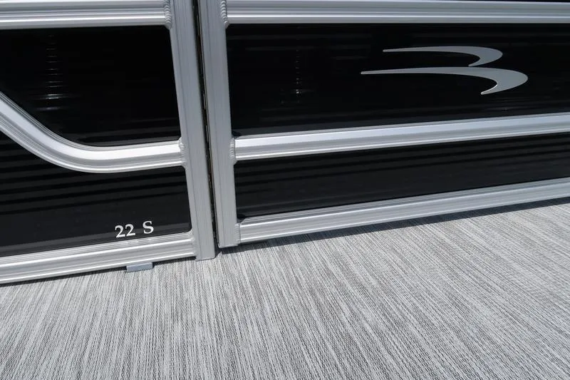 Slide: The Image of 2026 Bennington S Quad Bench 22 SSR, sleek black exterior detail. - 16