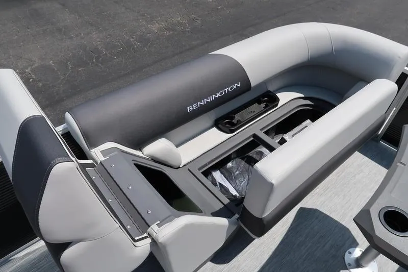 Slide: The Image of 2026 Bennington S Quad Bench 22 SSR boat seating with storage compartment open. - 26