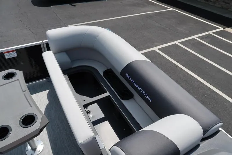 Slide: The Image of 2026 Bennington S Quad Bench 22 SSR with gray seating and cup holders. - 28