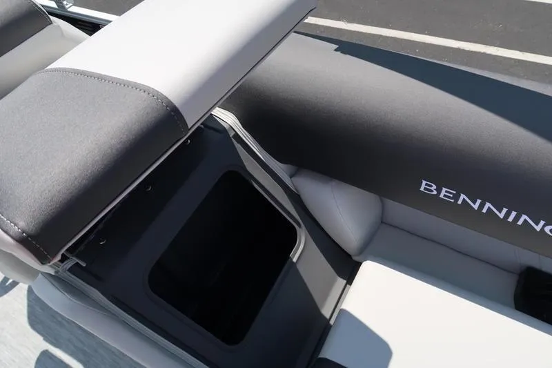 Slide: The Image of 2026 Bennington S Quad Bench 22 SSR boat seat with storage compartment open. - 29
