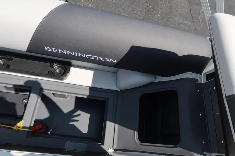 Slide: The Image of 2026 Bennington S Quad Bench 22 SSR boat interior with storage compartments. - 32