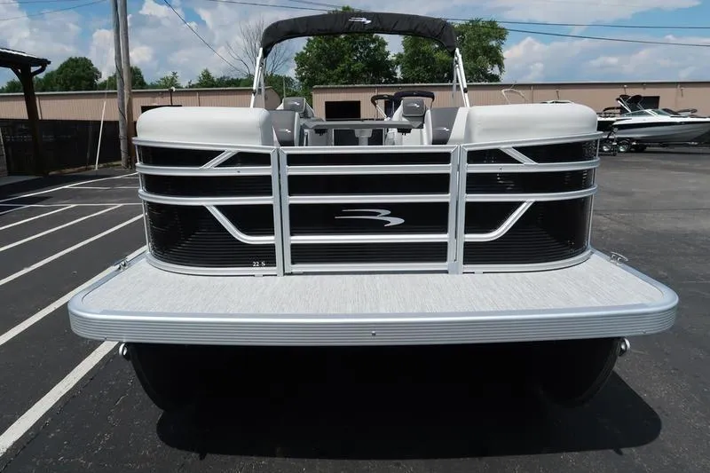 Slide: The Image of 2026 Bennington S Quad Bench 22 SSR pontoon boat, front view in parking lot. - 7