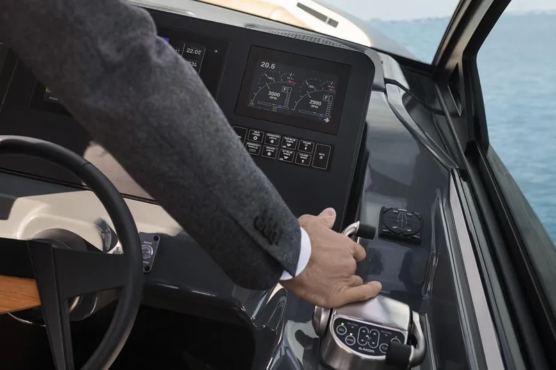 Slide: The Image of Manufacturer Provided Image: 2023 Aviara AV32 I/O boat dashboard with hand on throttle control. - 2