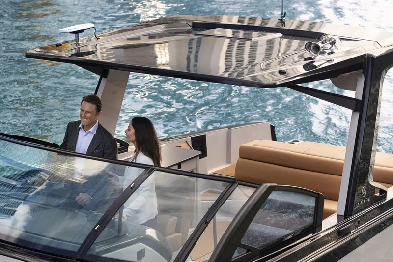 Slide: The Image of Manufacturer Provided Image: 2023 Aviara AV32 I/O luxury boat cruising on water with passengers. - 3