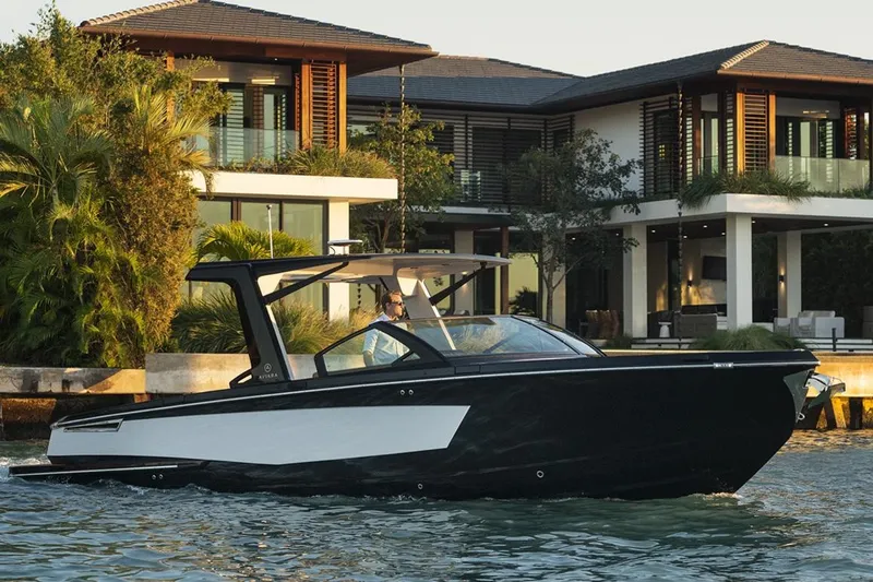 Slide: The Image of Manufacturer Provided Image: 2023 Aviara AV32 I/O luxury boat cruising near modern waterfront home. - 7