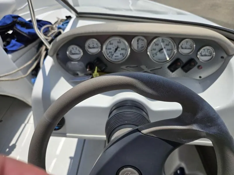Slide: The Image of Steering wheel and dashboard of a 2004 Glastron SX 195 boat. - 10