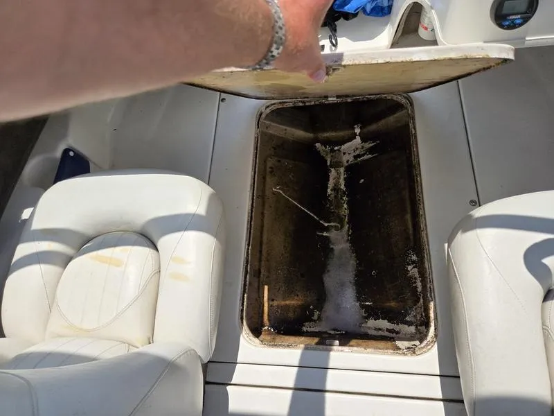 Slide: The Image of Open storage compartment in 2004 Glastron SX 195 boat with white seating. - 13