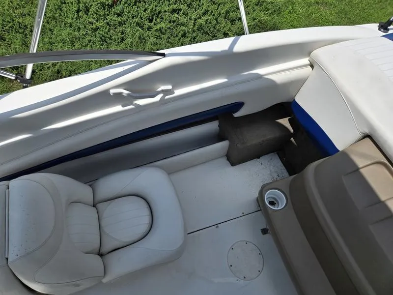 Slide: The Image of 2004 Glastron SX 195 boat interior with white seating and blue accents. - 15