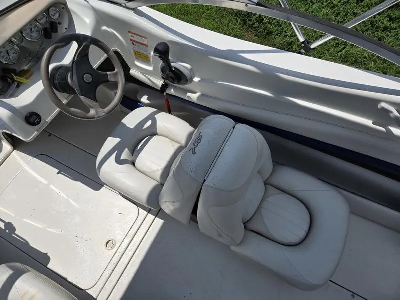 Slide: The Image of 2004 Glastron SX 195 boat interior with steering wheel and white seating. - 16