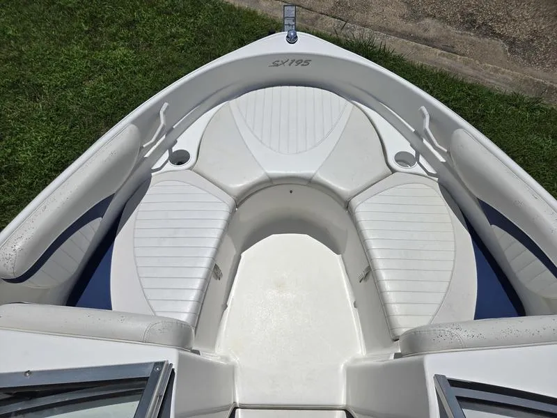 Slide: The Image of 2004 Glastron SX 195 boat interior with white seating and cup holders. - 3