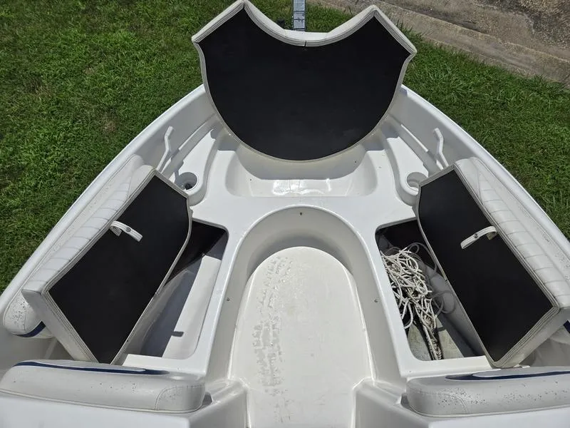 Slide: The Image of 2004 Glastron SX 195 boat interior with open storage compartments on grassy background. - 5