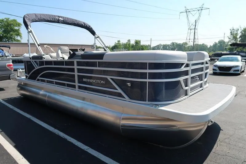 Slide: The Image of 2026 Bennington S Quad Bench 22 SSR pontoon boat interior with gray seating and table. - 10