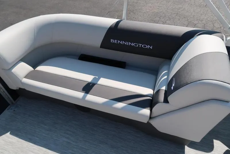Slide: The Image of 2026 Bennington S Quad Bench 22 SSR boat seating, featuring sleek black and white upholstery. - 17
