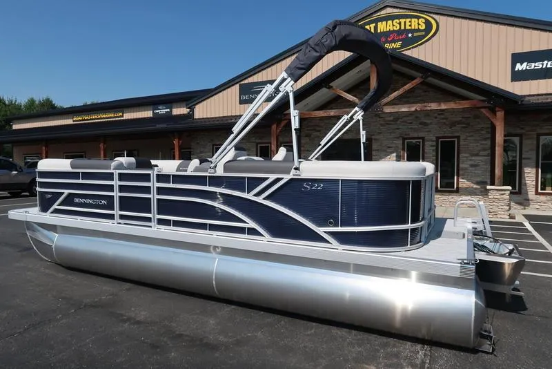 Slide: The Image of Close-up of 2026 Bennington S Quad Bench 22 SSR emblem on sleek surface. - 2