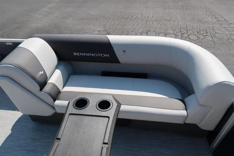 Slide: The Image of 2026 Bennington S Quad Bench 22 SSR boat dashboard with steering wheel and gauges. - 23