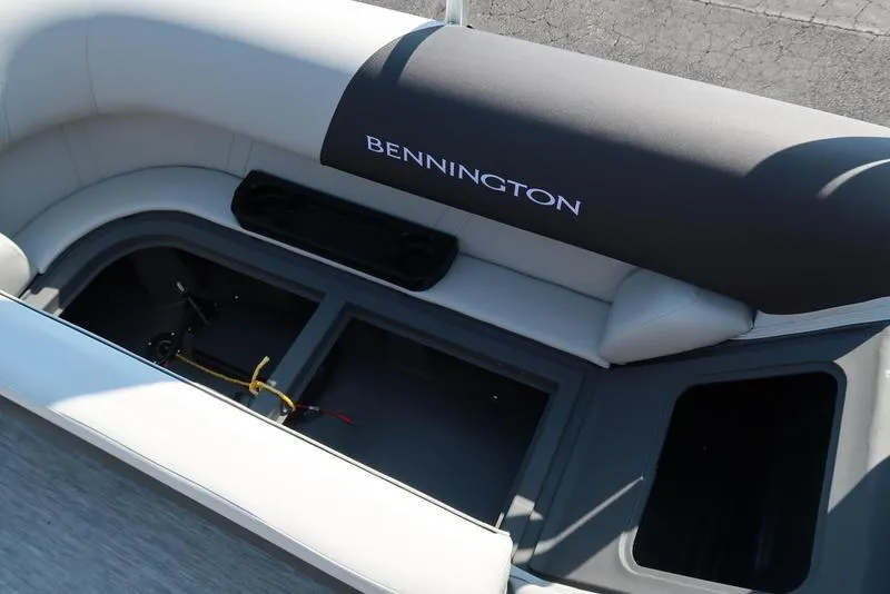 Slide: The Image of 2026 Bennington S Quad Bench 22 SSR boat interior with storage compartment open. - 26