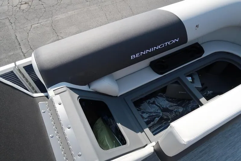 Slide: The Image of 2026 Bennington S Quad Bench 22 SSR boat interior with storage and cup holders. - 30
