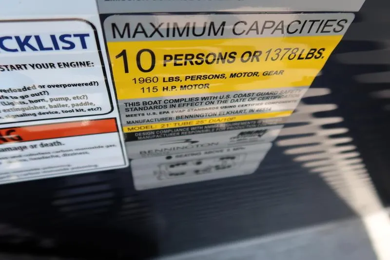 Slide: The Image of 2026 Bennington S Quad Bench 22 SSR boat interior with open storage compartment. - 32