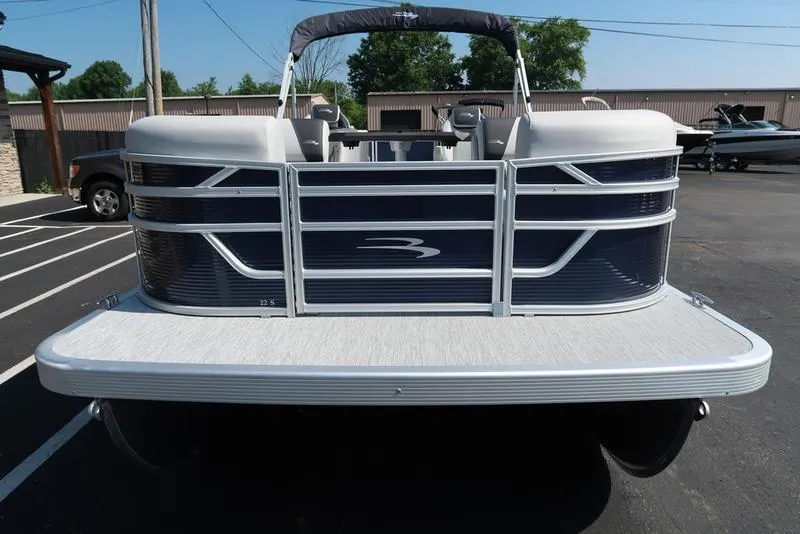Slide: The Image of 2026 Bennington S Quad Bench 22 SSR pontoon boat in a parking lot. - 4