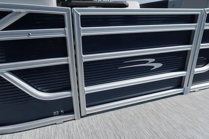 Slide: The Image of 2026 Bennington S Quad Bench 22 SSR pontoon boat parked outdoors. - 6