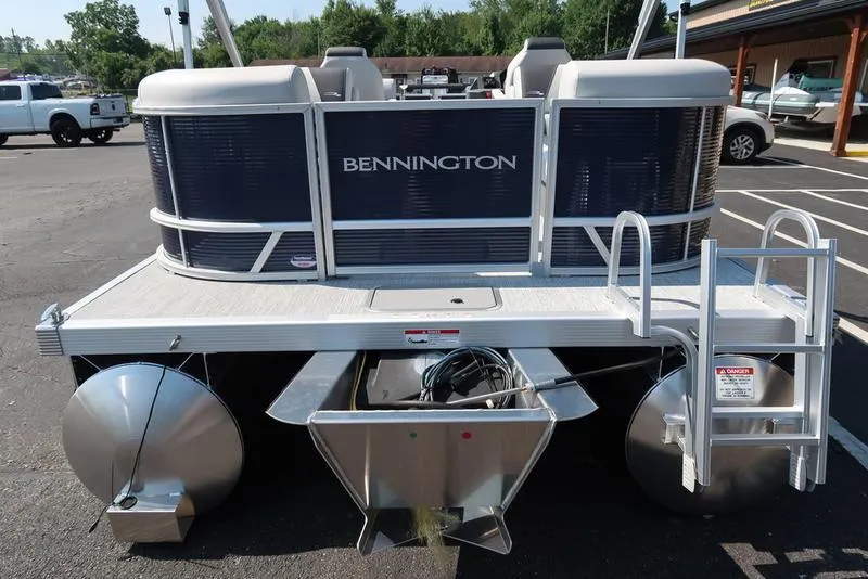 Slide: The Image of 2026 Bennington S Quad Bench 22 SSR pontoon boat, rear view in parking lot. - 9