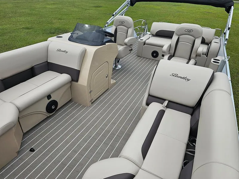 Slide: The Image of 2026 Bentley Pontoons 223 Legacy Swingback interior with beige seating and striped flooring. - 11