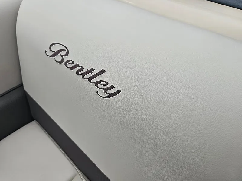 Slide: The Image of 2026 Bentley Pontoons 223 Legacy Swingback interior with luxurious seating and striped flooring. - 24