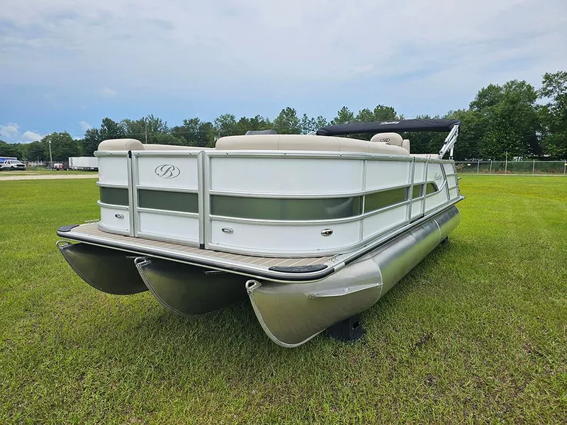 Slide: The Image of 2026 Bentley Pontoons 223 Legacy Swingback on grass, featuring sleek design and ladder. - 5