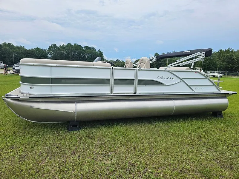 Slide: The Image of 2026 Bentley Pontoons 223 Legacy Swingback on grass, showcasing sleek design and luxury features. - 6