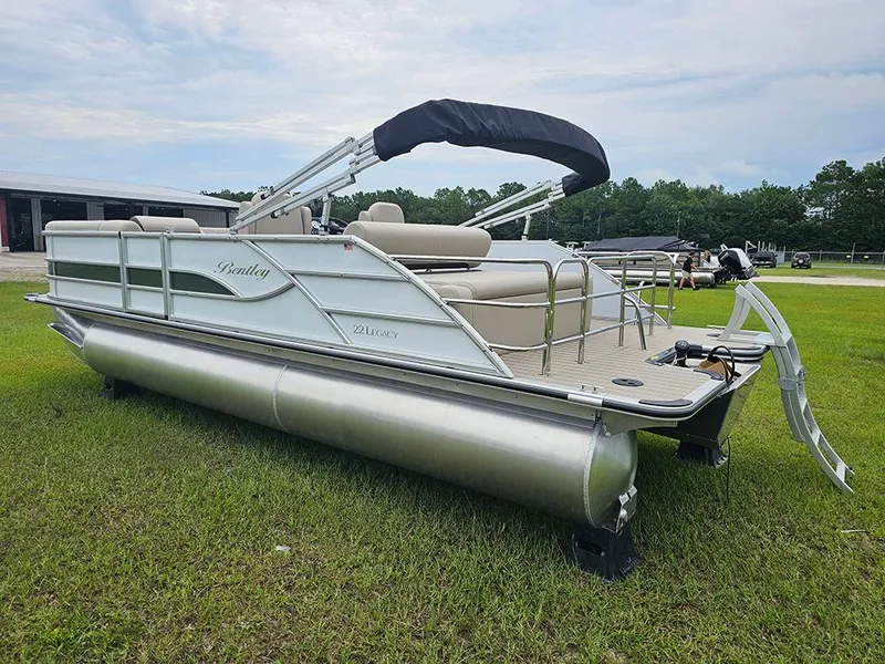 Slide: The Image of 2026 Bentley Pontoons 223 Legacy Swingback on grass, showcasing sleek design and modern features. - 7
