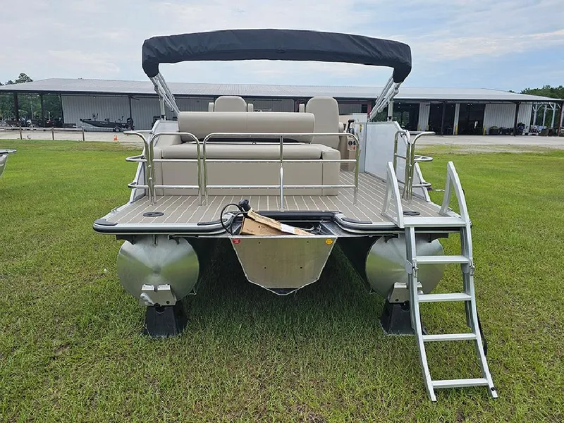 Slide: The Image of 2026 Bentley Pontoons 223 Legacy Swingback on grassy field, side view. - 8