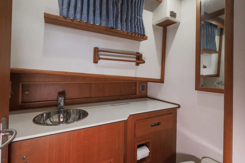 Slide: The Image of Bathroom interior of 2002 Grand Banks 46 Europa yacht with wooden cabinetry and stainless steel sink. - 14