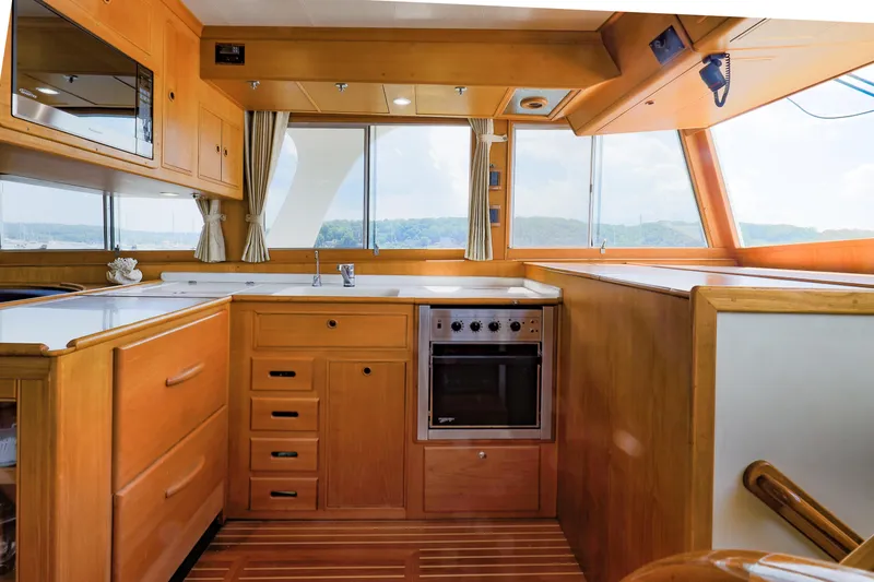 Slide: The Image of Interior of 2002 Grand Banks 46 Europa yacht kitchen with wood cabinetry and modern appliances. - 24