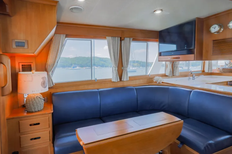 Slide: The Image of Luxurious interior of 2002 Grand Banks 46 Europa yacht with blue seating and scenic window view. - 28