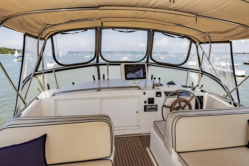 Slide: The Image of Interior view of 2002 Grand Banks 46 Europa yacht helm with scenic ocean backdrop. - 29