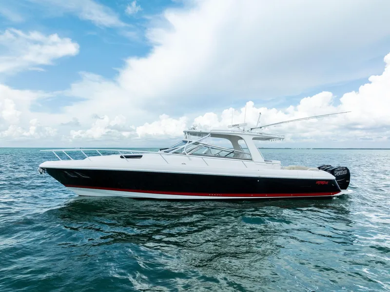 The Image of 2018 Intrepid 430 Sport Yacht cruising on open sea under cloudy sky. - 0