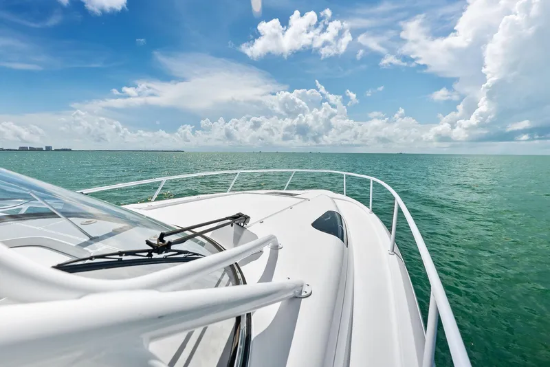 Slide: The Image of 2018 Intrepid 430 Sport Yacht cruising on clear blue ocean under a bright sky. - 13