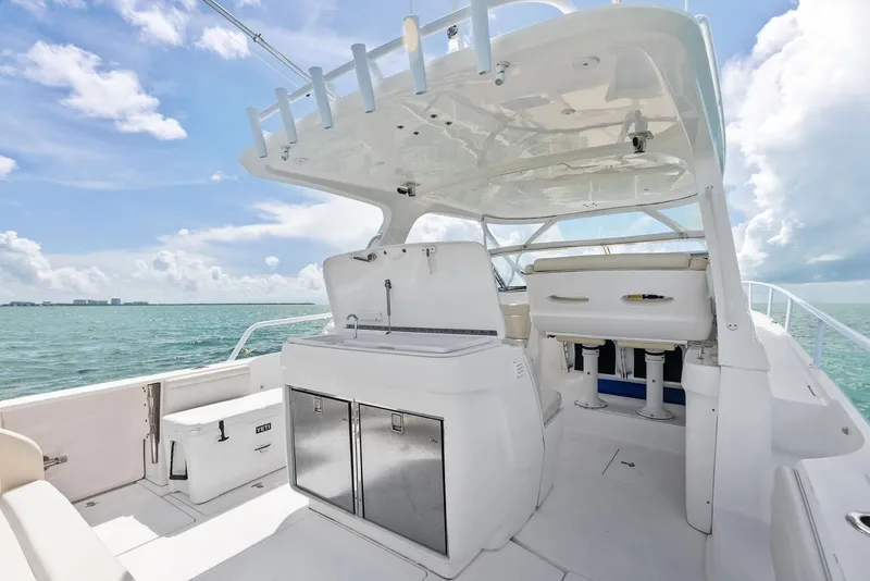 Slide: The Image of 2018 Intrepid 430 Sport Yacht interior with seating, storage, and ocean view. - 16