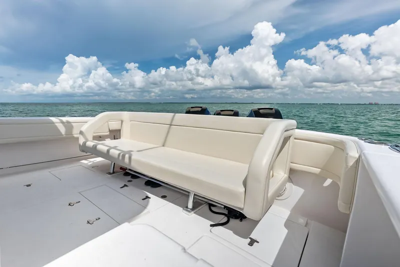Slide: The Image of 2018 Intrepid 430 Sport Yacht deck with seating, ocean view, and blue sky. - 21