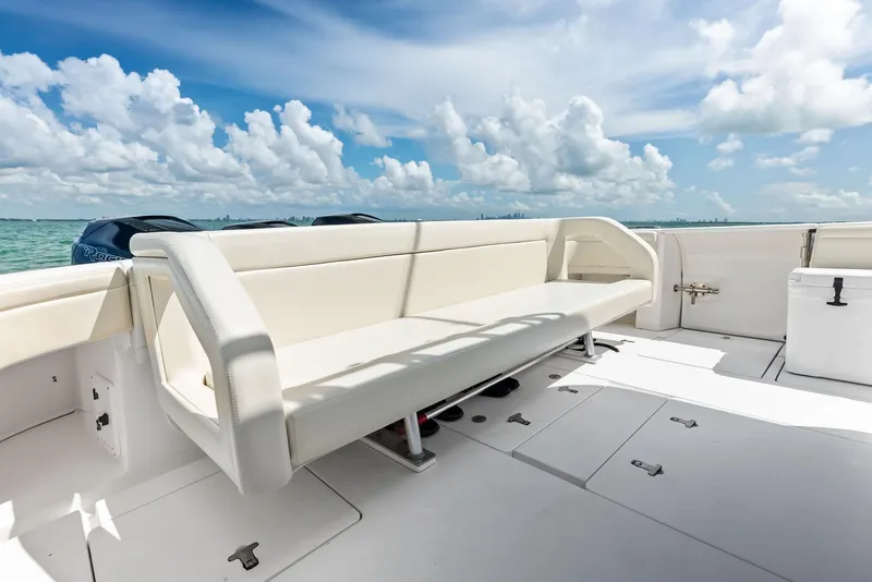 Slide: The Image of 2018 Intrepid 430 Sport Yacht deck with seating, ocean view, and clear skies. - 22