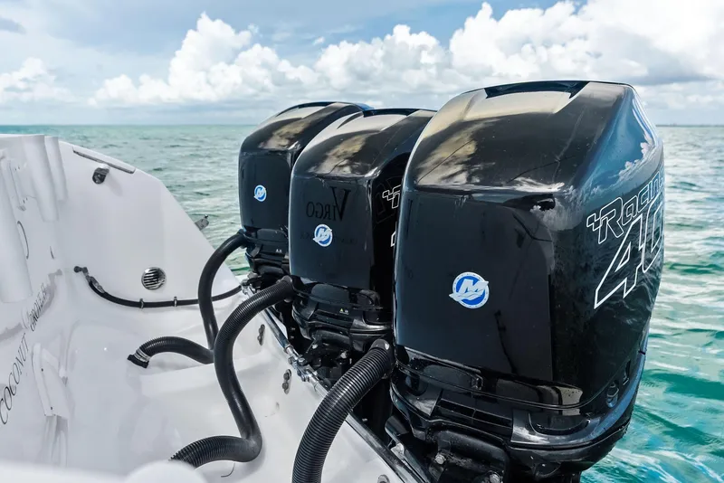 Slide: The Image of 2018 Intrepid 430 Sport Yacht with triple outboard engines on open water. - 25