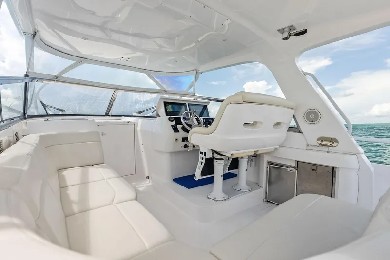 Slide: The Image of 2018 Intrepid 430 Sport Yacht interior with white seating and helm, overlooking ocean. - 26