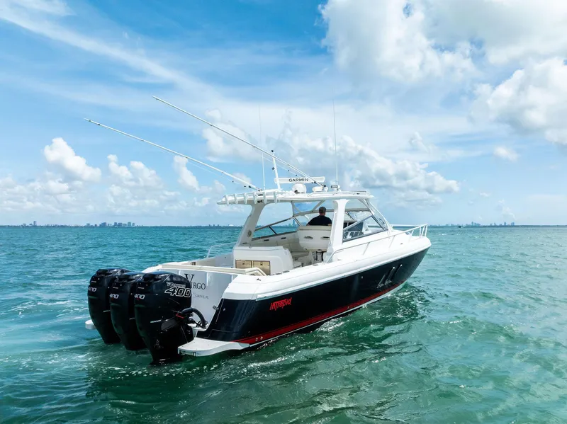 Slide: The Image of 2018 Intrepid 430 Sport Yacht on open water with triple outboard engines. - 3