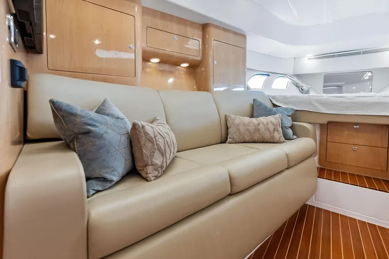 Slide: The Image of Luxurious interior of 2018 Intrepid 430 Sport Yacht with beige sofa and decorative pillows. - 37