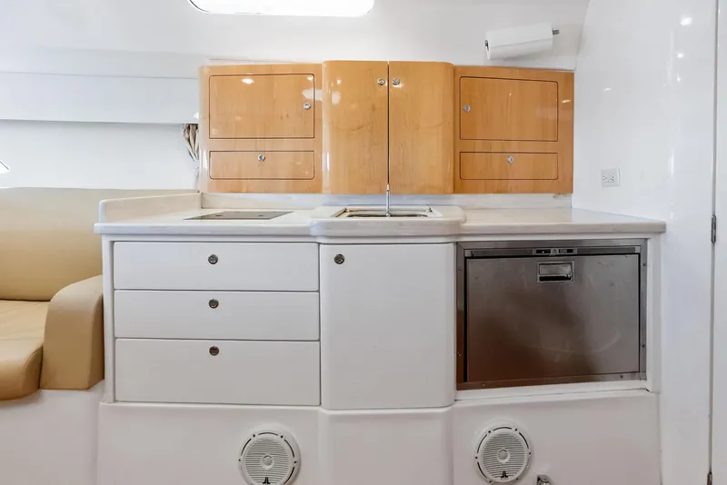 Slide: The Image of 2018 Intrepid 430 Sport Yacht interior kitchen with cabinets, sink, and dishwasher. - 39