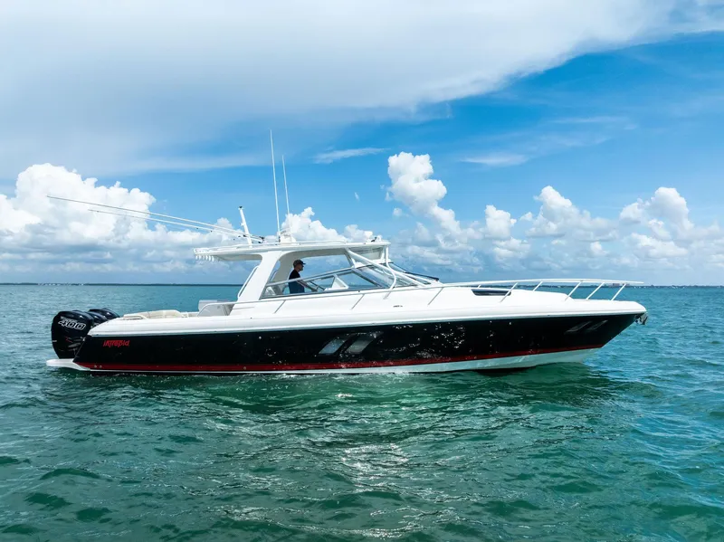 Slide: The Image of 2018 Intrepid 430 Sport Yacht cruising on open water under a clear blue sky. - 4